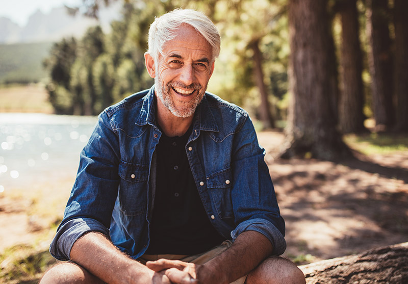 man outdoors by lake